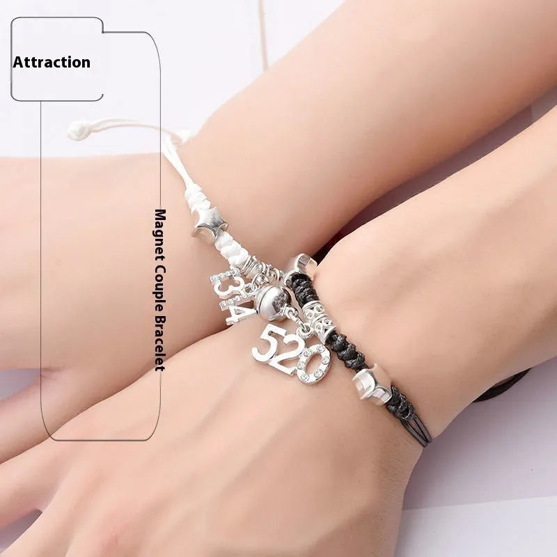 Pair of magnet couple bracelets with suction clasp on wrist, showing alloy designs like crown and love lock.