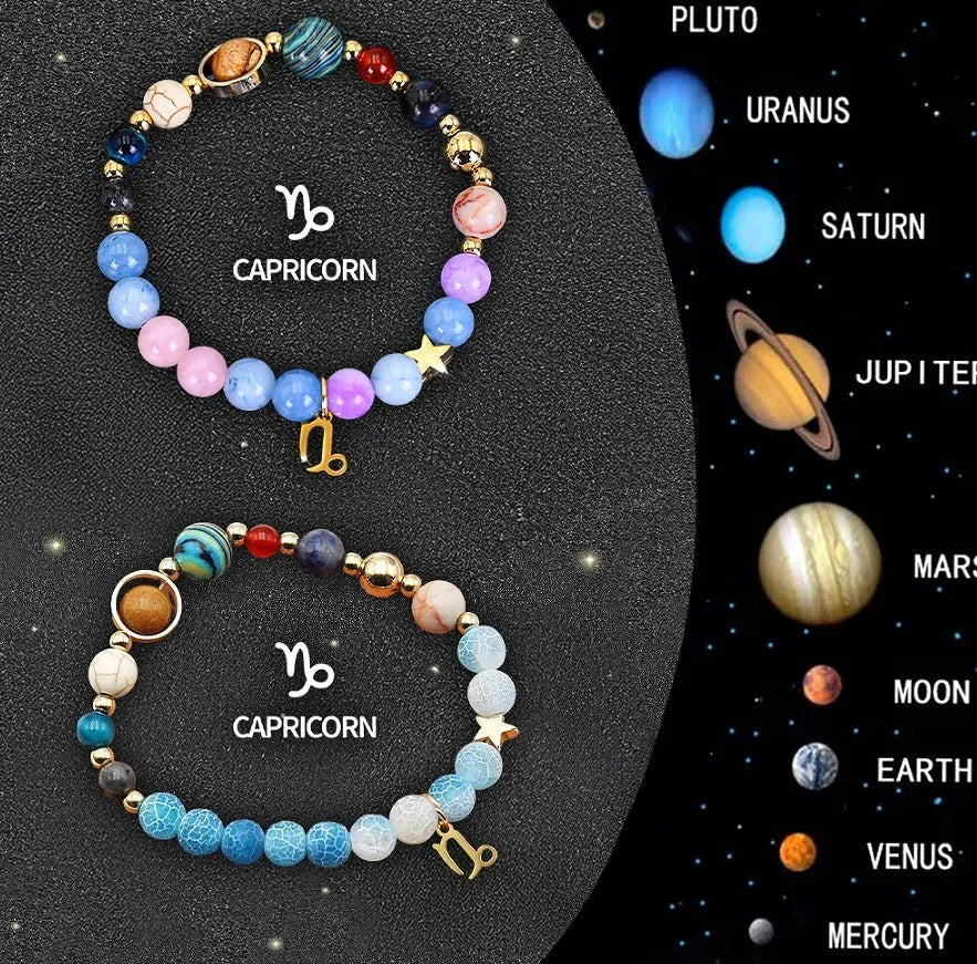 Set of two natural stone beaded bracelets with zodiac sign charms on a white background.