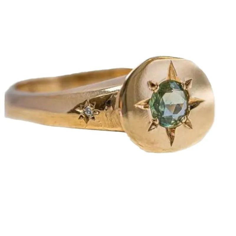 Gold star ring with oval zircon stone on an adjustable zinc alloy band.