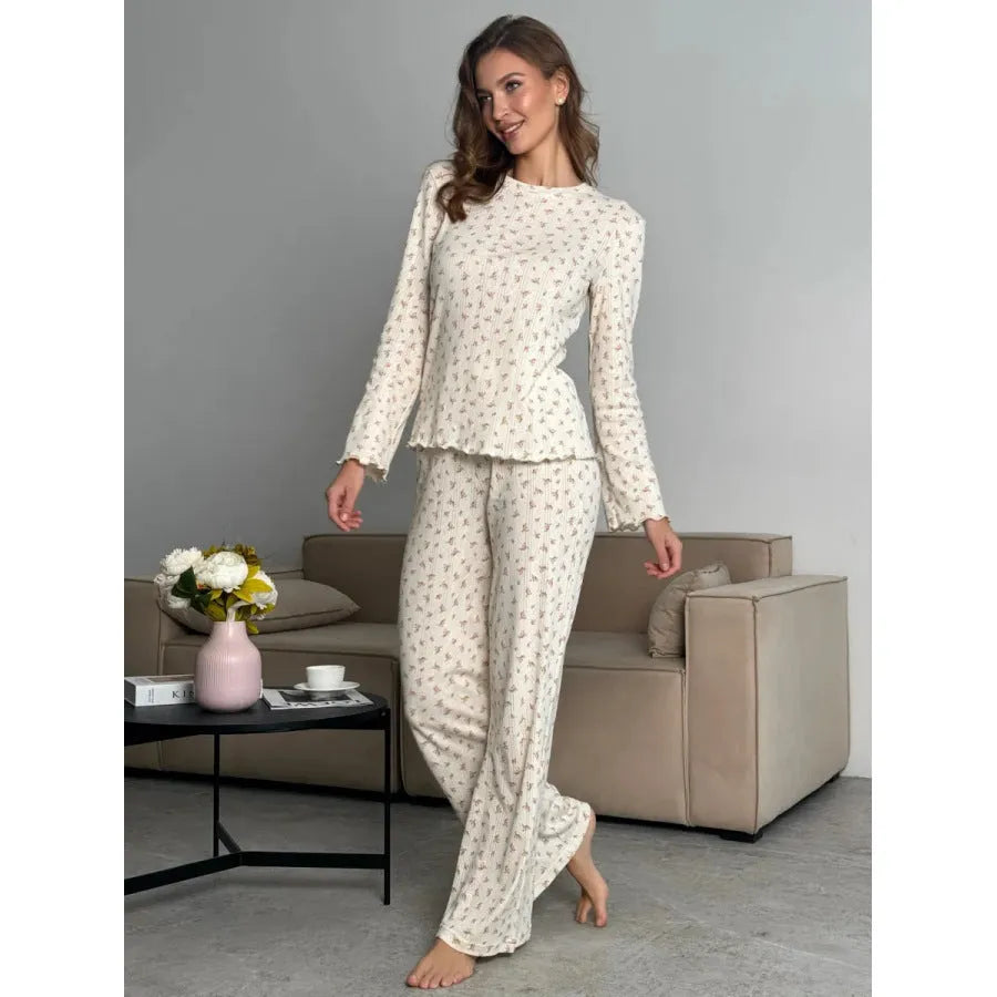 White floral print women's bell sleeve top and wide leg trousers suit on hanger