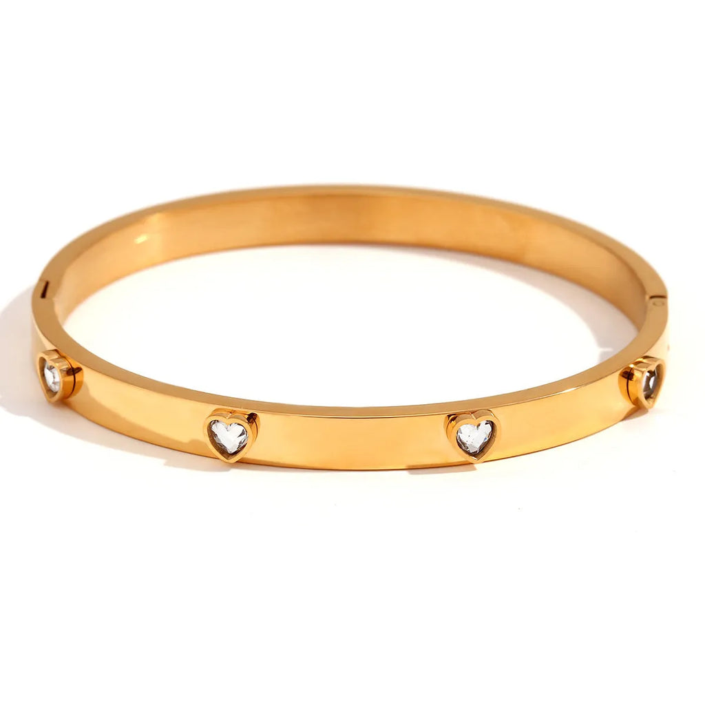 Women's stainless steel bracelet with micro-inlaid peach heart charm in golden electroplated finish