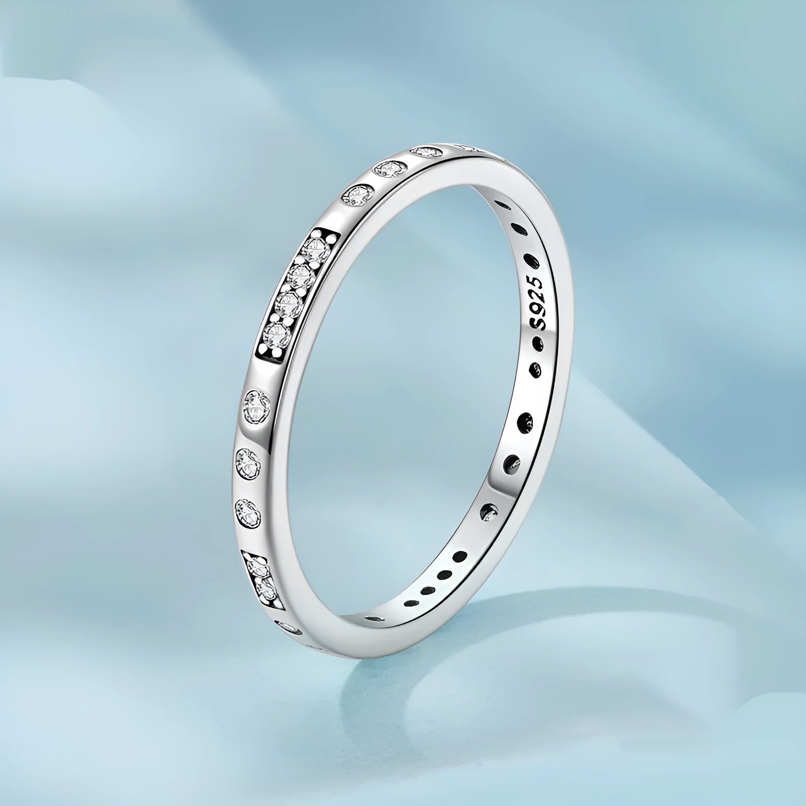 Women's oxidised black silver 'I Love You' ring with moss password design on a hand.
