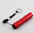 Black aluminium mini LED flashlight showing compact size and textured grip.