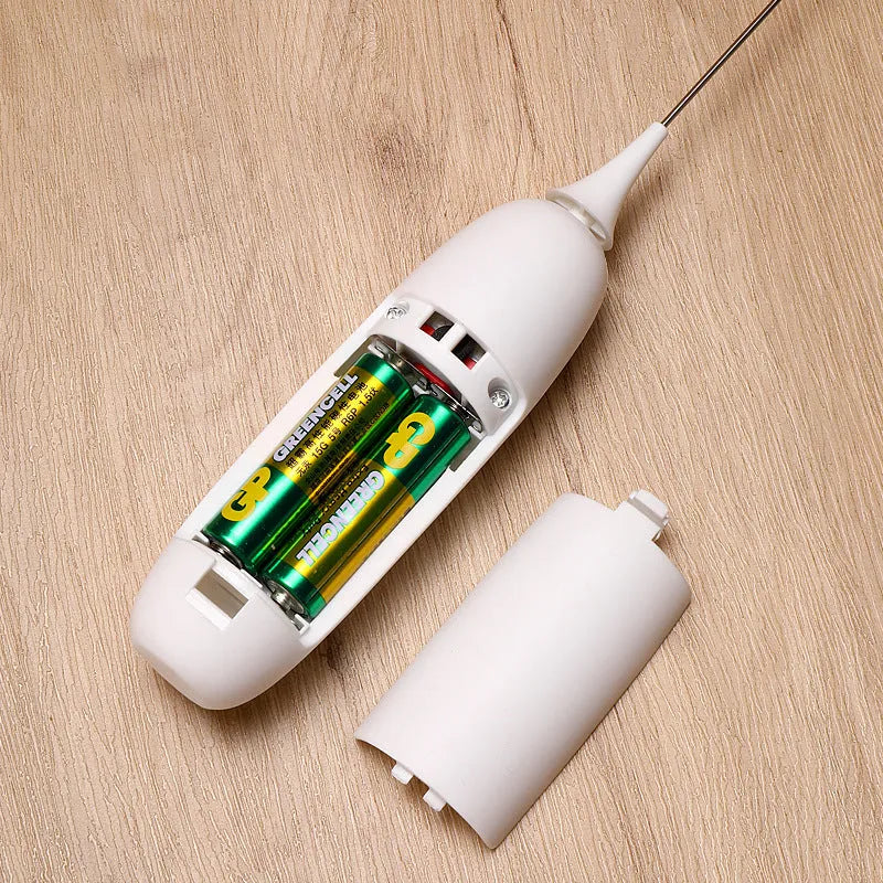 Black and white electric hand-held milk frother for coffee drinks