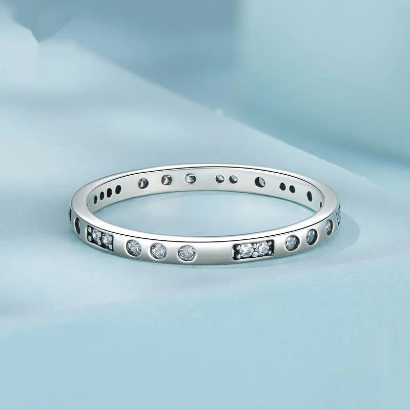 Women's oxidised black silver 'I Love You' ring with moss password design on a hand.