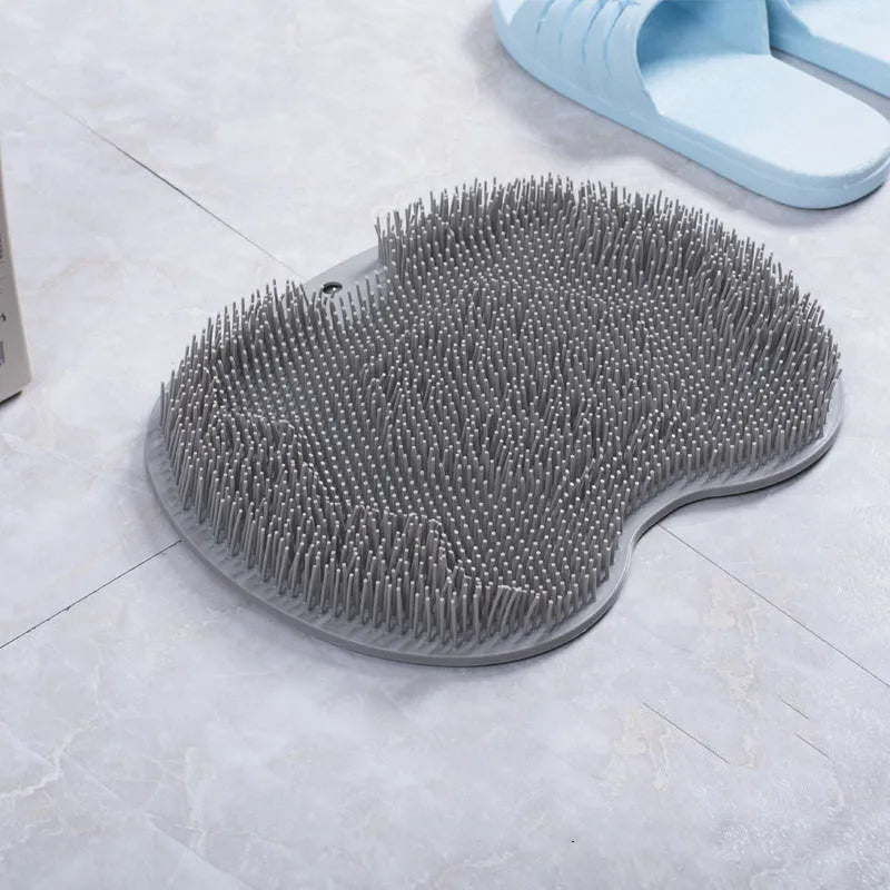 Orange silicone bristle bath brush with suction cups on base, size 23x30cm, for foot and back cleaning.