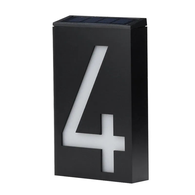Solar-powered white LED house number light mounted on an outdoor wall