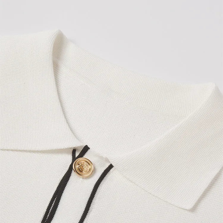 White short sleeve cardigan with contrasting colour lapels on a hanger.