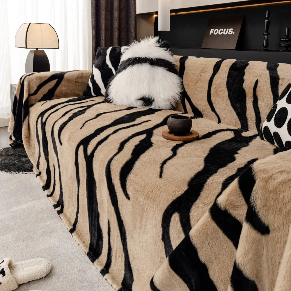 Zebra pattern flannel sofa slipcover in caramel colour, shown draped over a sofa.