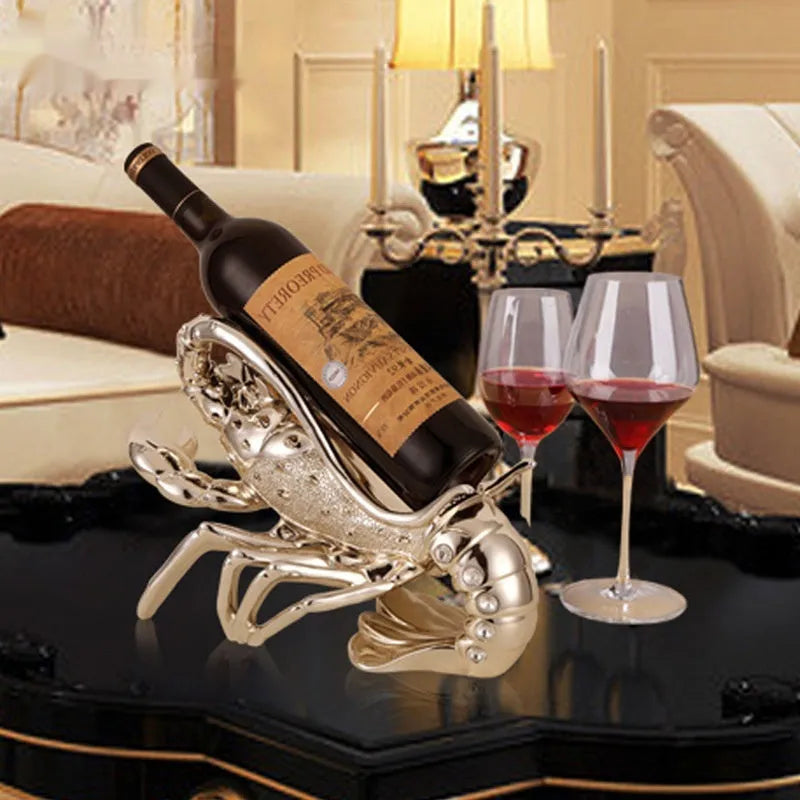 Lobster-shaped wine rack theme ornament in rose gold or silver resin and plastic finish on a shelf.