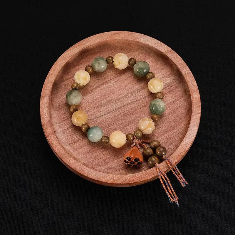 Carved pumpkin lotus bodhi root bracelet with white jade segments and golden silk jade treasures