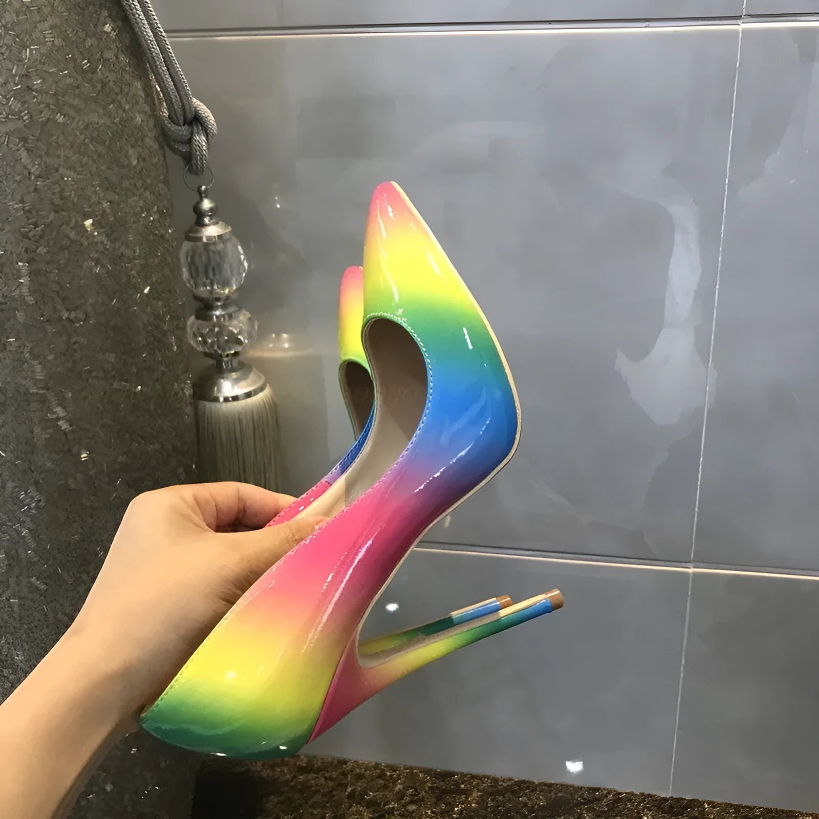 Rainbow patent leather women's ultra-high heel shoes with pointed toe and thin stiletto heel.