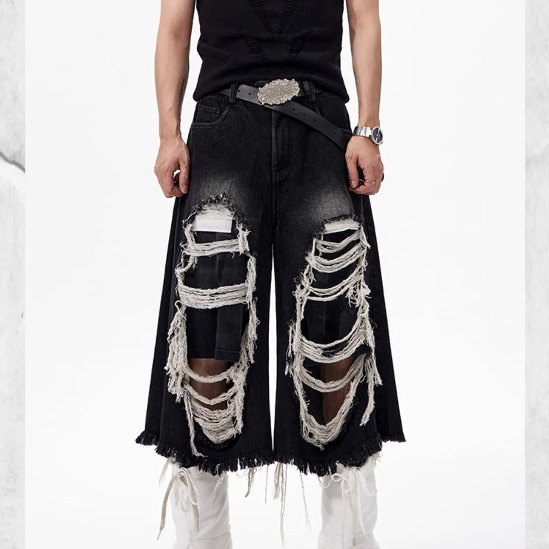 Black wide leg cropped jeans with mid-high waist and ripped patch detail on micro-elastic cotton denim