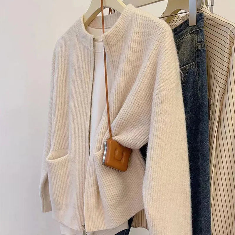 Beige soft viscose knit cardigan with long sleeves shown on a hanger.