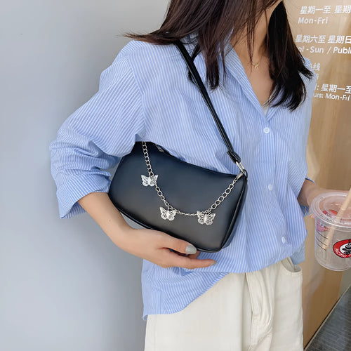 Butterfly chain crossbody bag in PU leather with a retro style, shown in light blue.