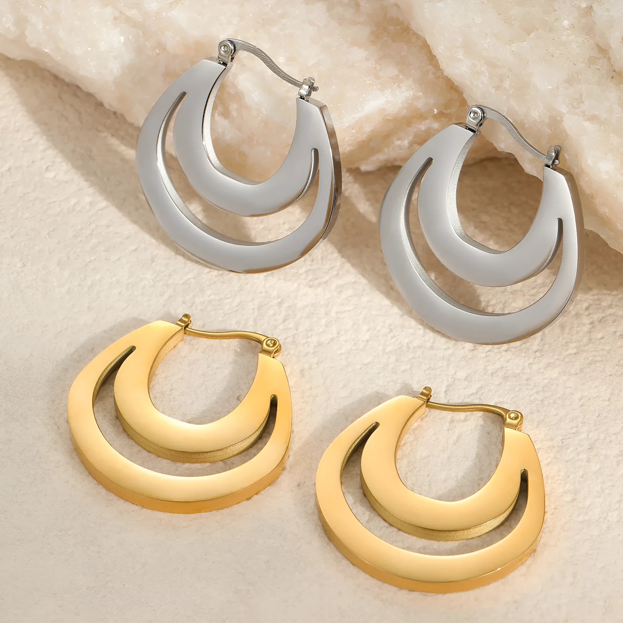 Geometric gold plated hoop earrings with round ring design on stainless steel background
