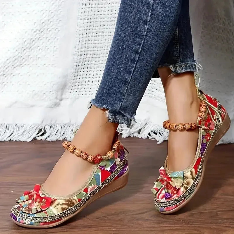 Women's plus size black ethnic platform sandals with elastic band and cloth upper.
