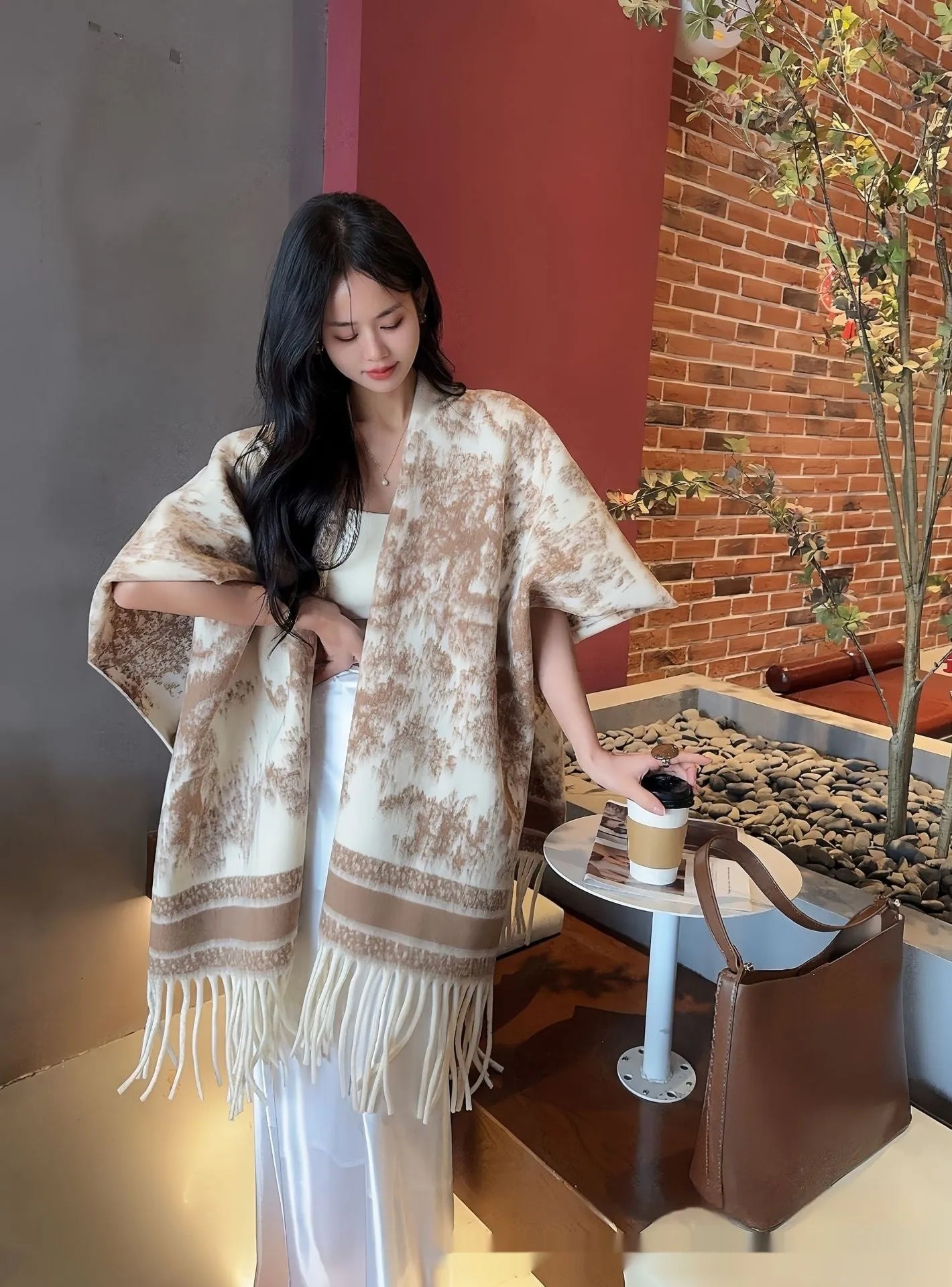 Women's polyester scarf cape with tassel edges worn as shawl in casual style