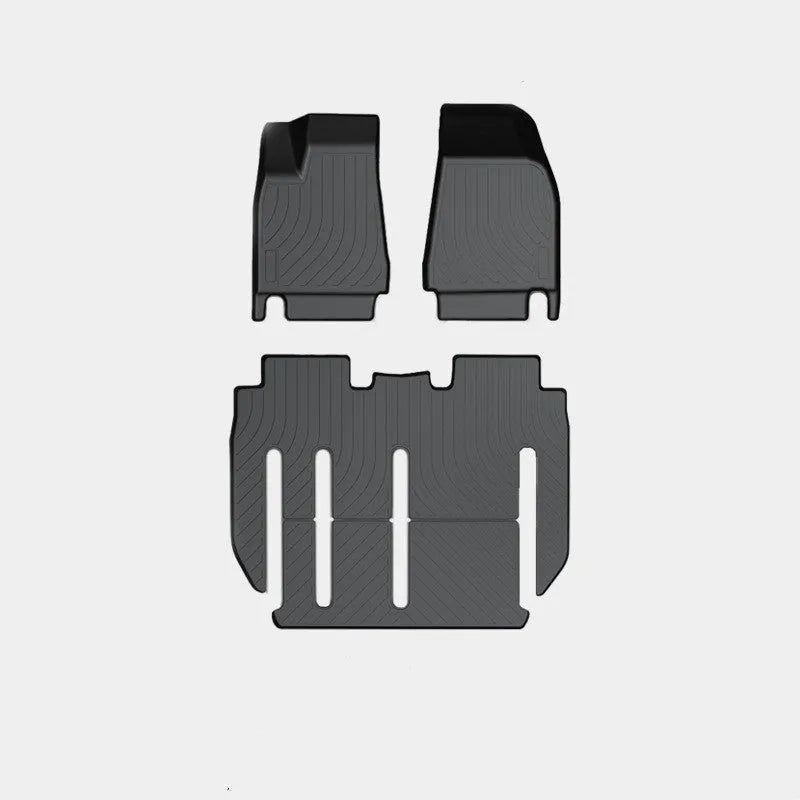 Tesla Model X black TPE rubber floor mats and boot liner set on car interior.