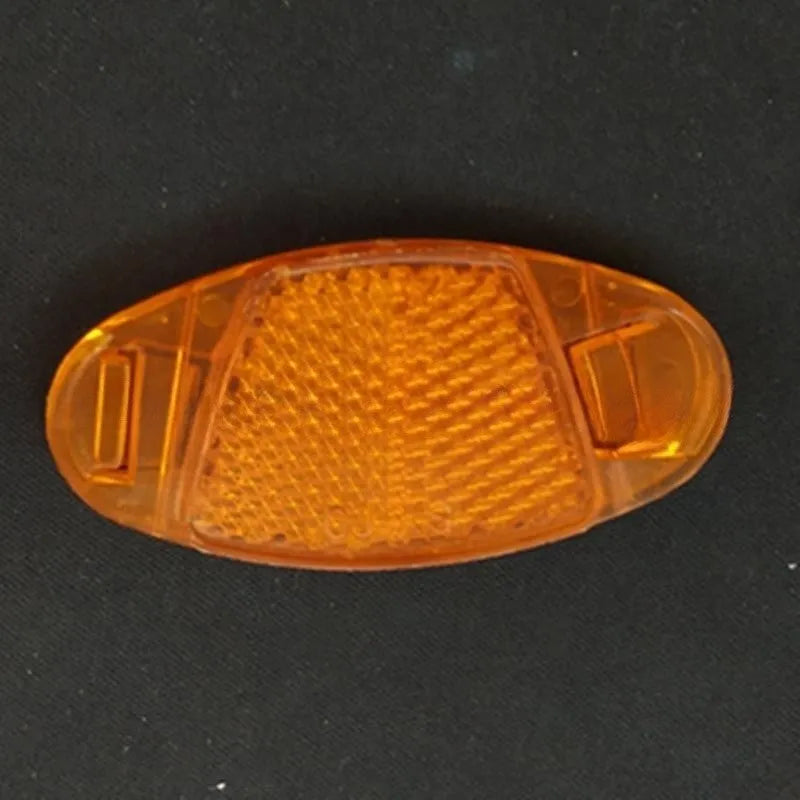 Yellow bicycle wheel reflector with hot wheels design mounted on spoke