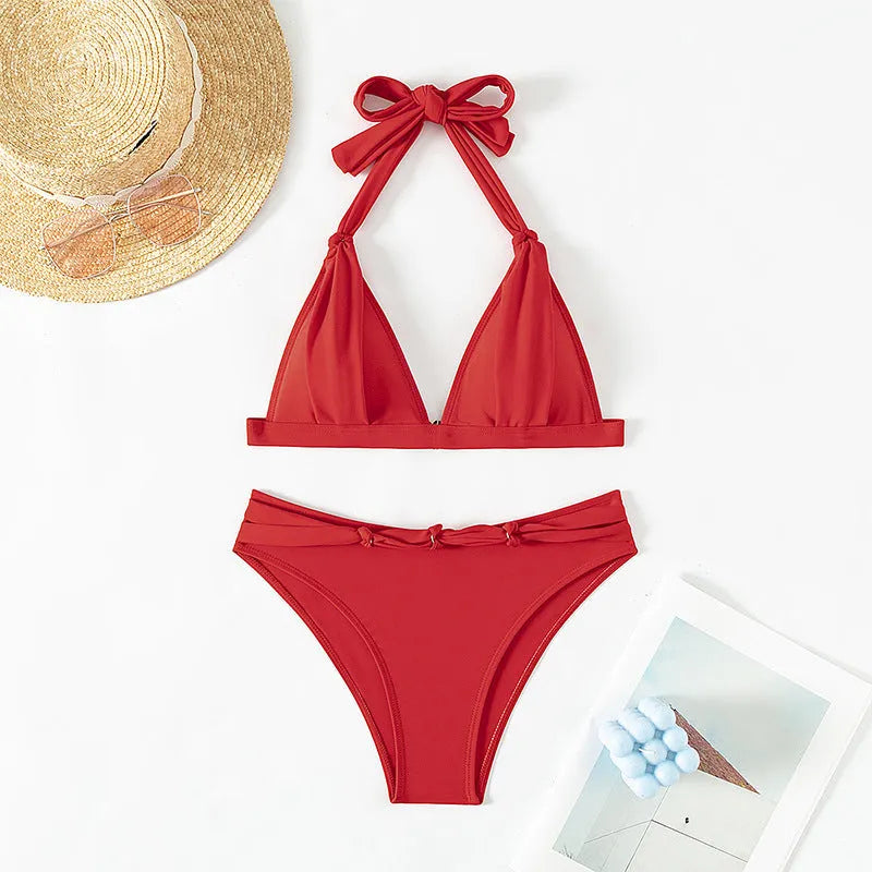 Red women's lace-up halterneck bikini set with split-leg shorts for beach swimming