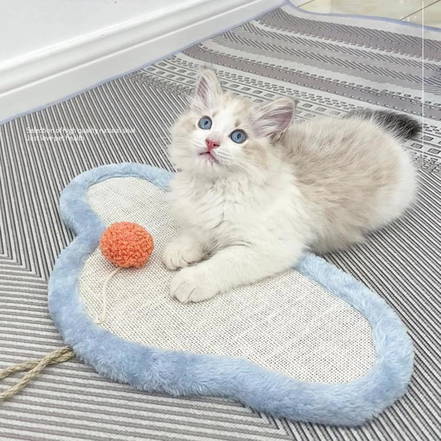White cat scratching mat with sleeping cat pattern, made from natural sisal, shown mounted on a wall