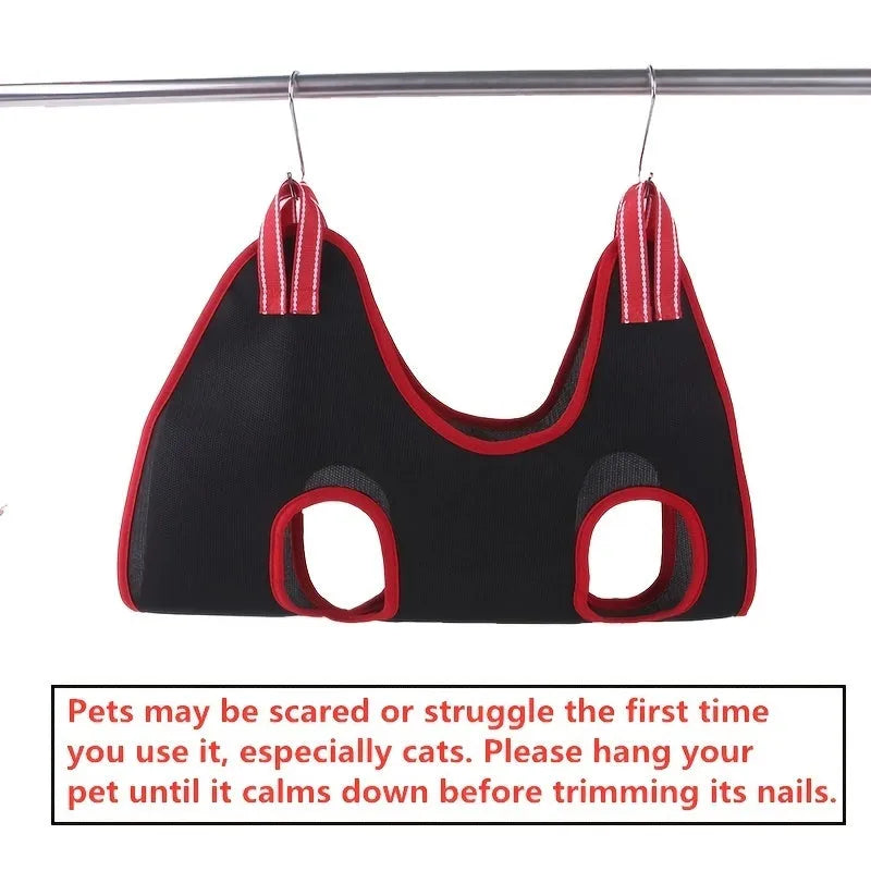 Blue pet grooming hammock restraint bag with mesh panels and elastic straps hanging from a door.