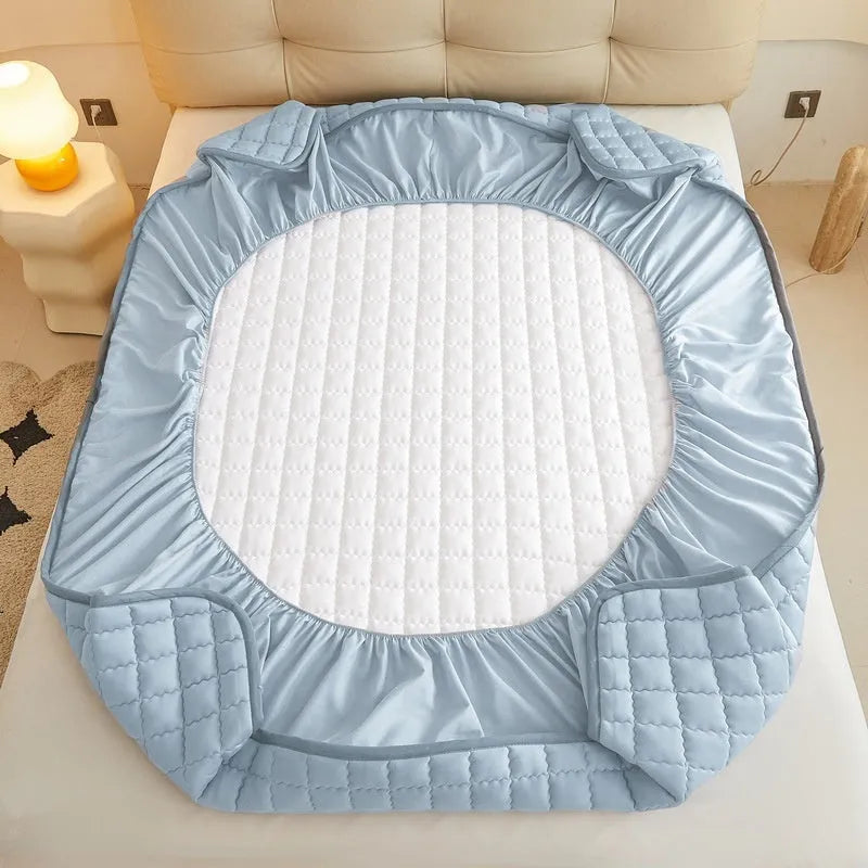 Class A waterproof fitted sheet in light grey colour, shown fitted neatly on a mattress.