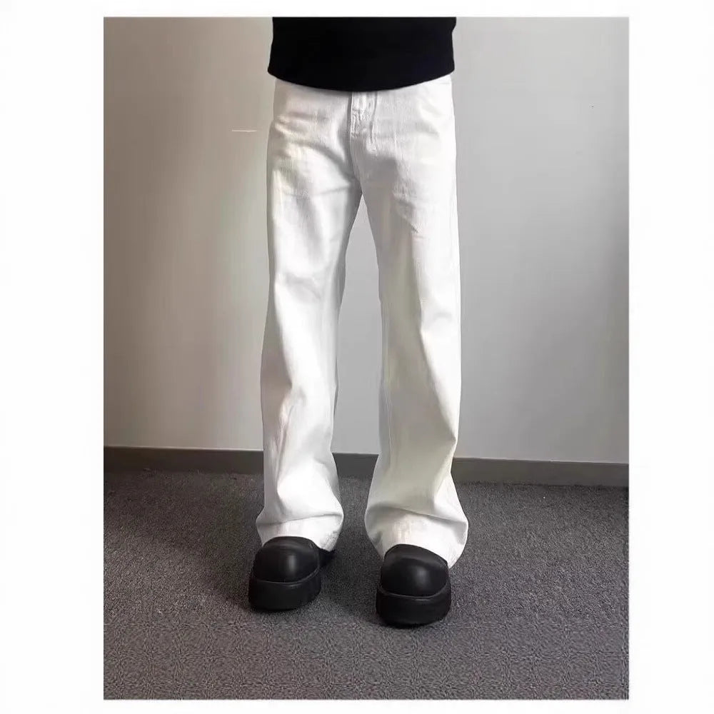 A pair of men's white wide-leg straight jeans with a mid-rise waist and zipper fly on a plain background.