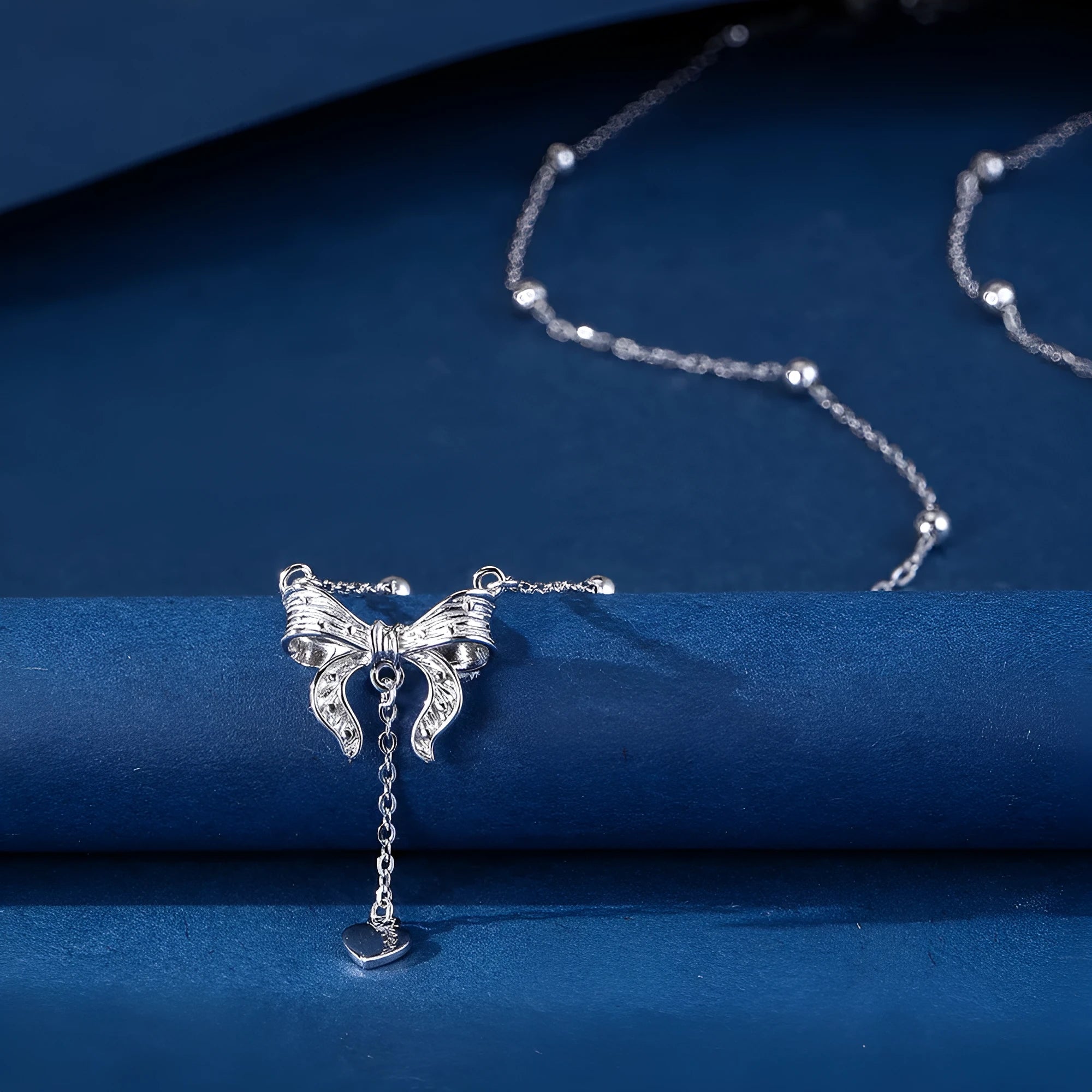 S925 silver butterfly heart necklace on adjustable O-ring chain showing heart pendant with bow and butterfly details