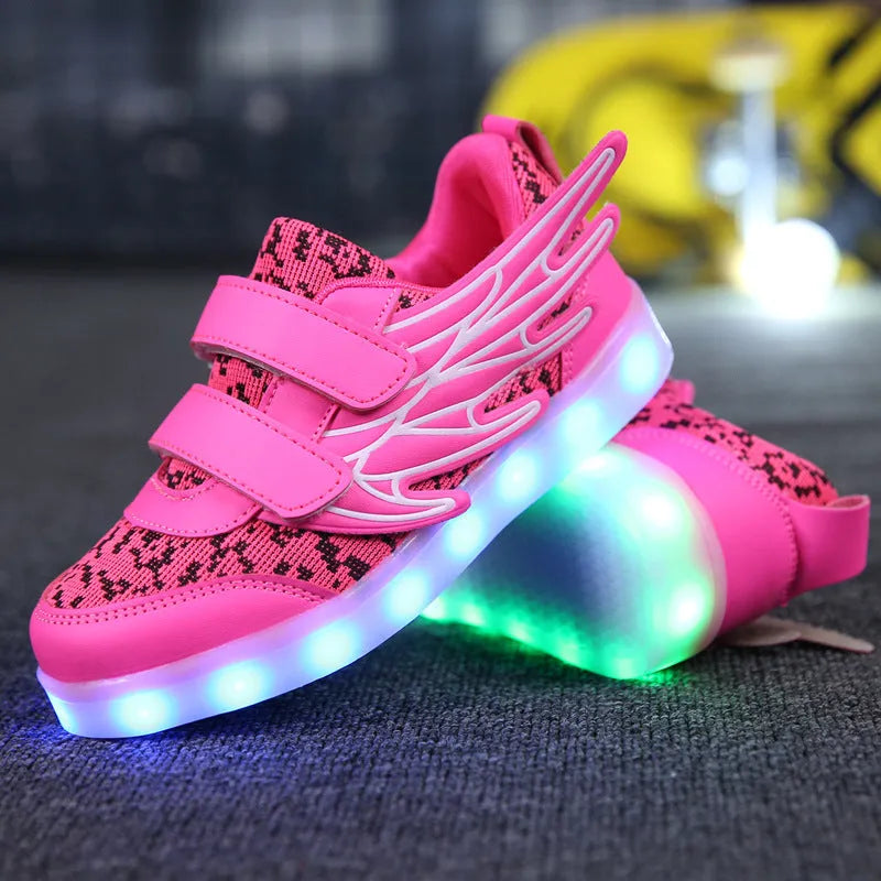 Children's plum red sneakers with multicolour LED lights glowing on the soles.