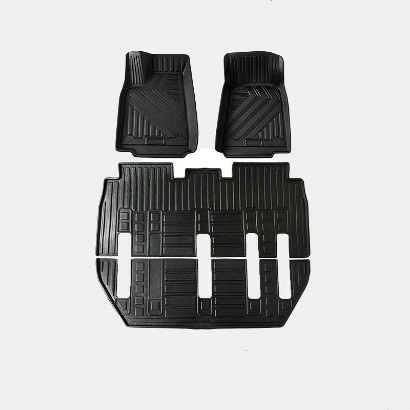 Tesla Model X black TPE rubber floor mats and boot liner set on car interior.