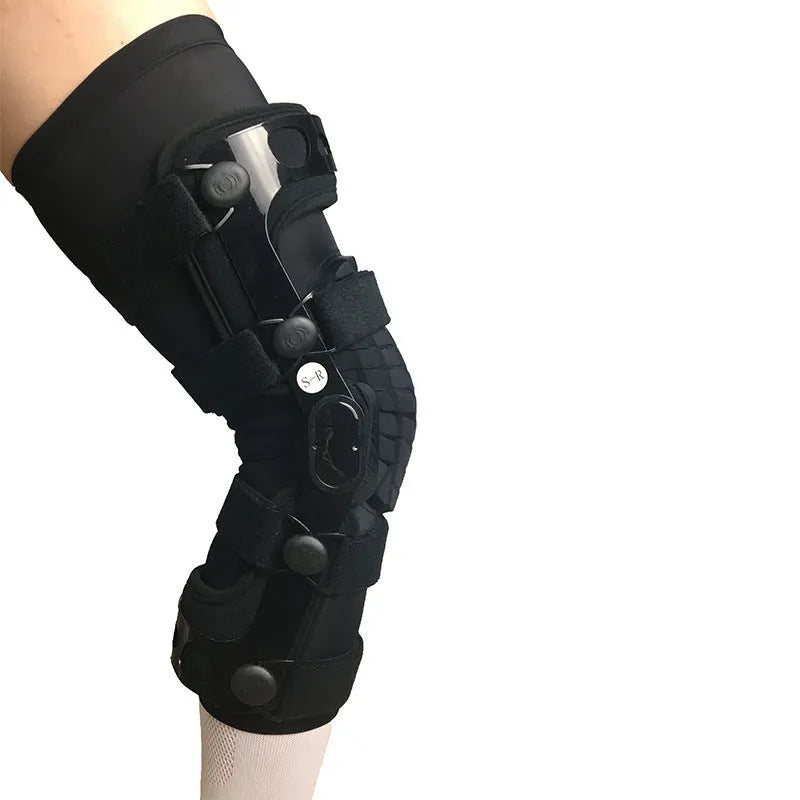 Black anterior ligament knee pad with adjustable straps shown from side view