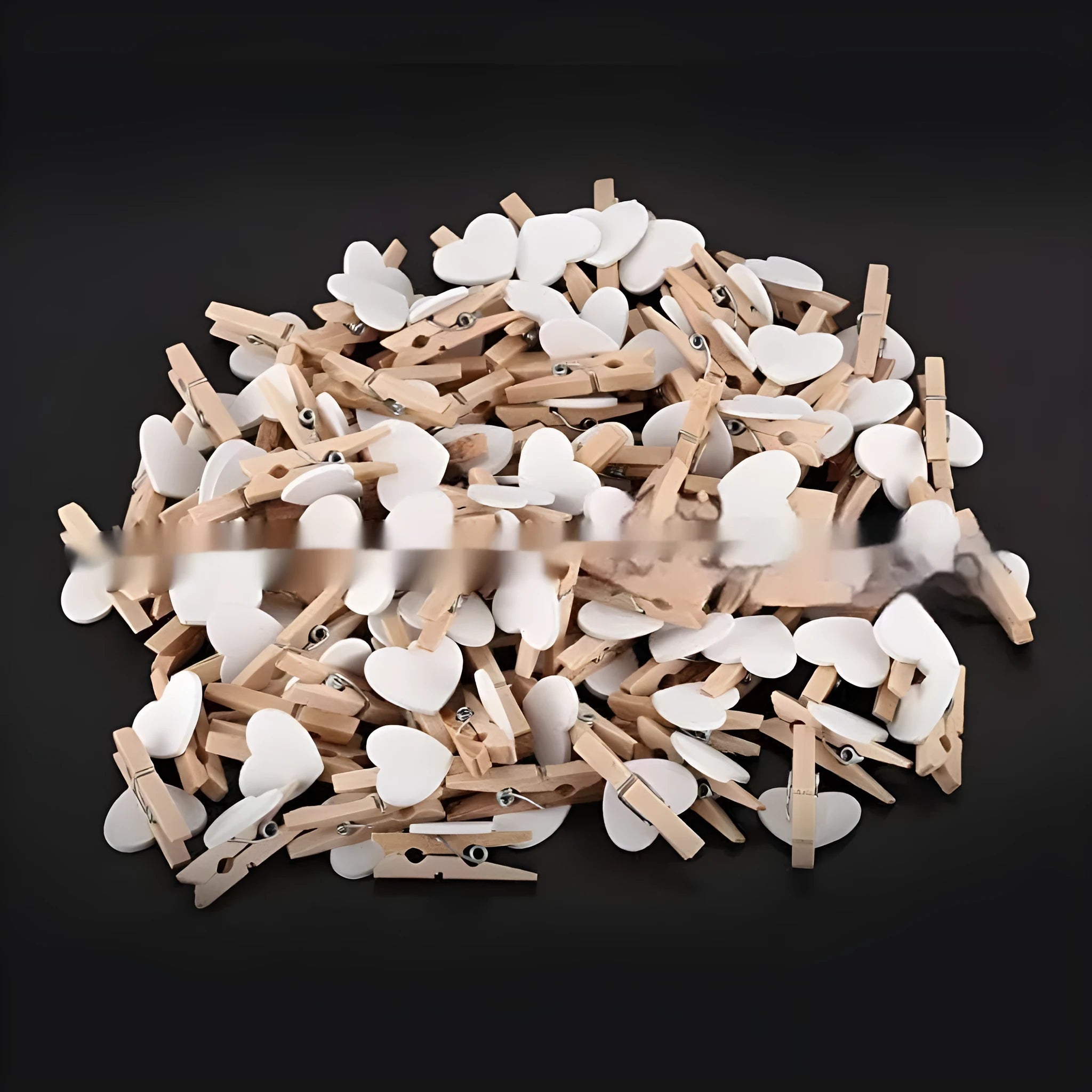 Five handmade wooden heart-shaped clips in red, white, and rose red on a plain background.