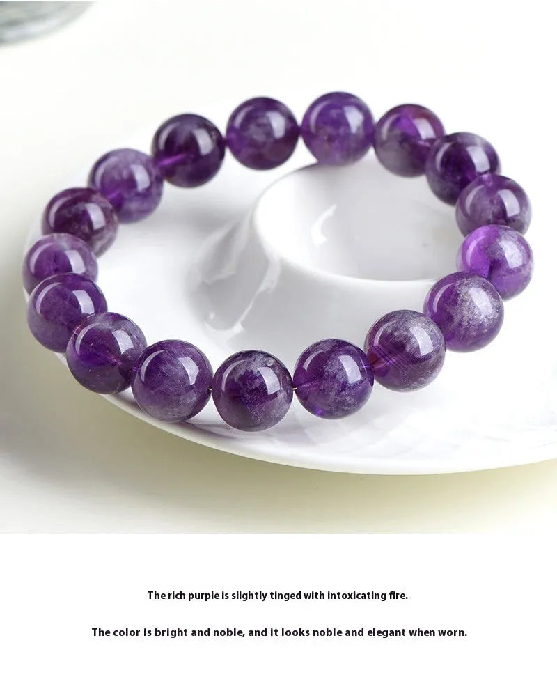 Natural feather amethyst crystal bracelet with geometric shape and silver fastener on wrist.