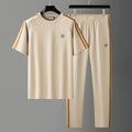 Men's blue ice silk style short sleeve suit set with matching trousers on a hanger