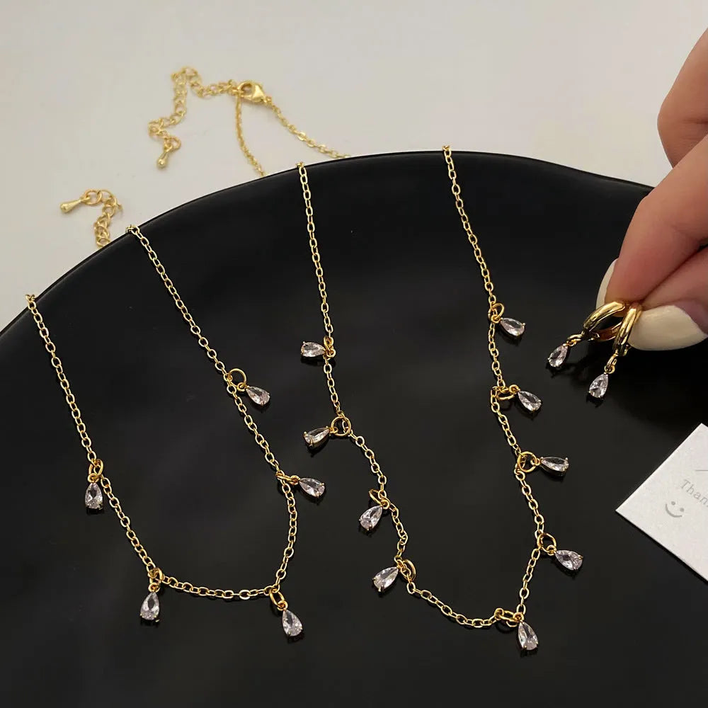 Women's zircon jewellery set showing geometric necklace, matching earrings, and anklet with meteor shower design.