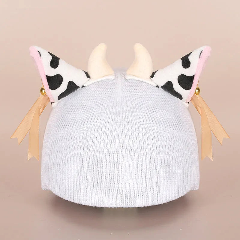 Plush fabric ski helmet decoration with cartoon design on a black ski helmet.