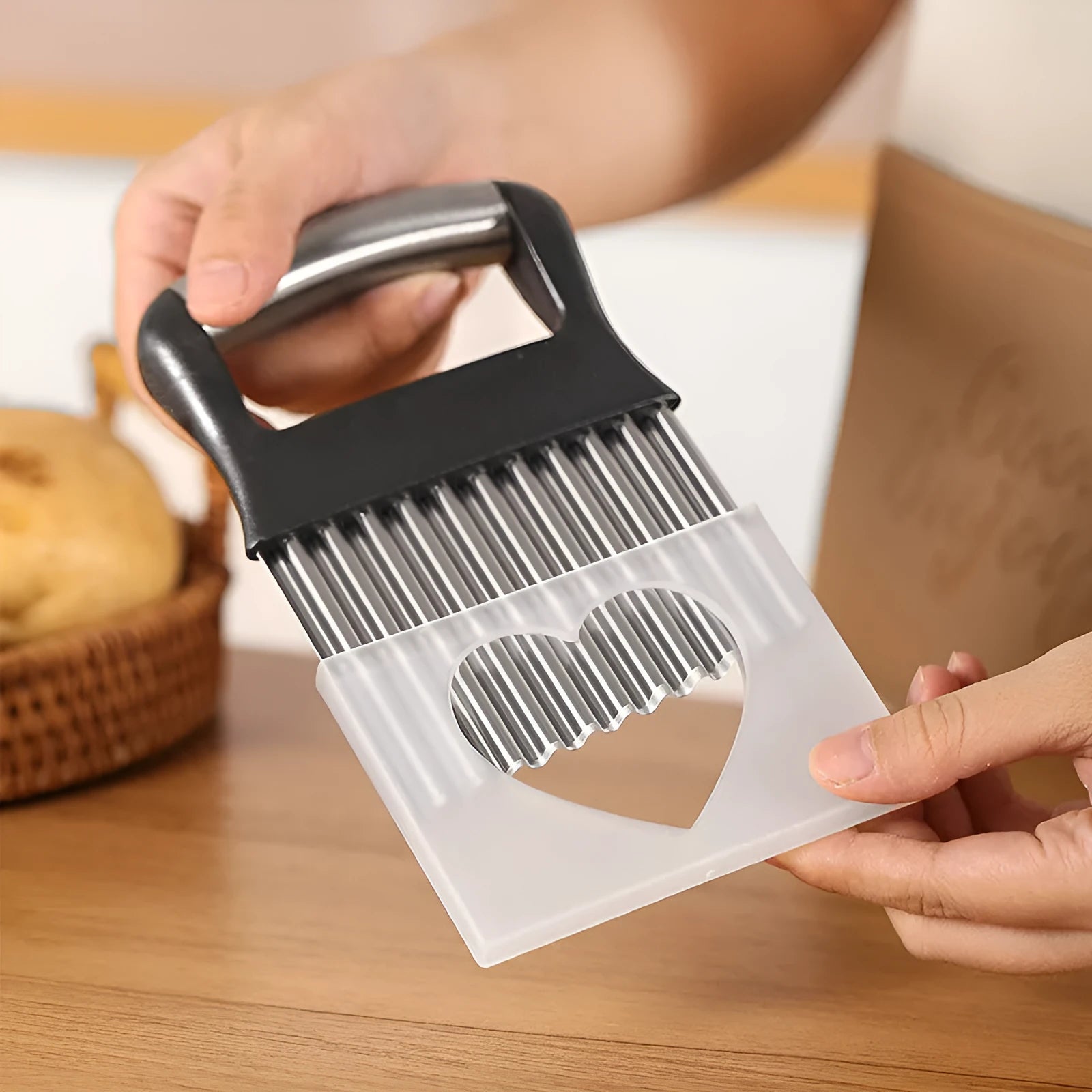 Stainless steel potato wave knife with serrated blade on a kitchen counter.