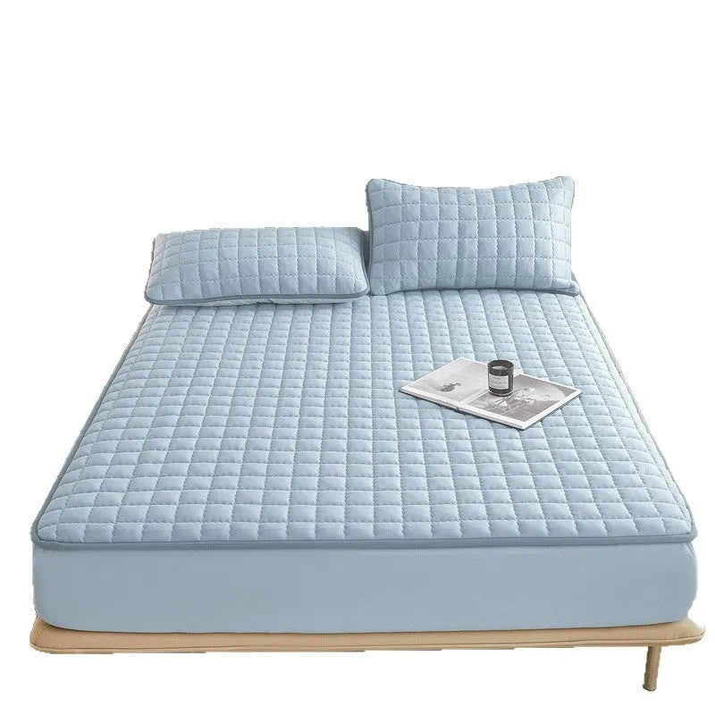Class A waterproof fitted sheet in light grey colour, shown fitted neatly on a mattress.