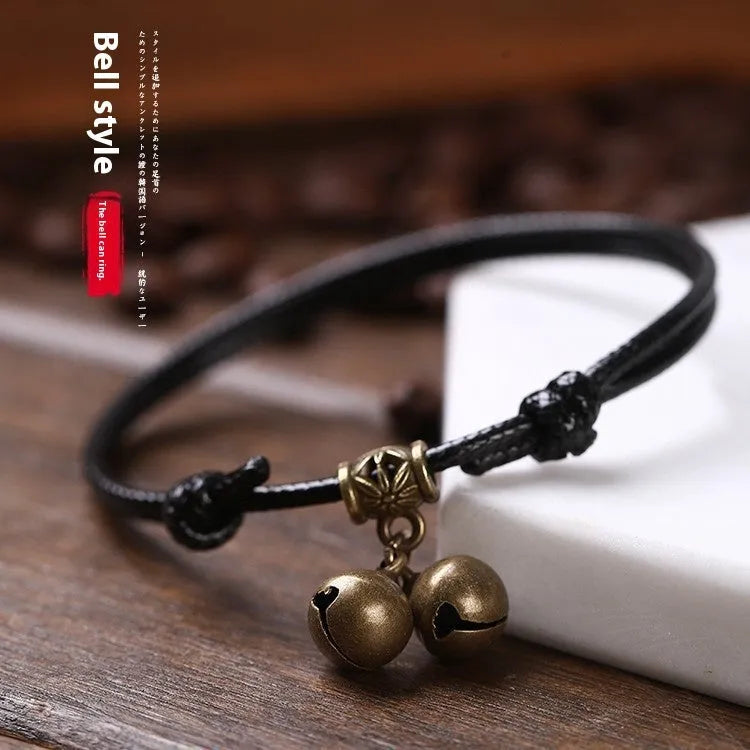 Small dog wearing adjustable nylon rope collar with brass bell in black, red or coffee colour