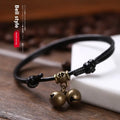 Small dog wearing adjustable nylon rope collar with brass bell in black, red or coffee colour