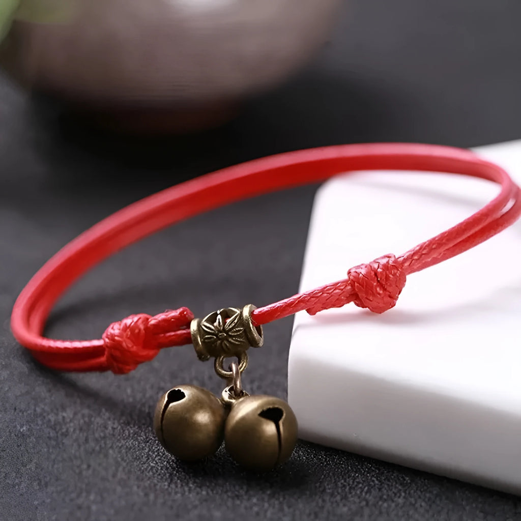 Small dog wearing adjustable nylon rope collar with brass bell in black, red or coffee colour