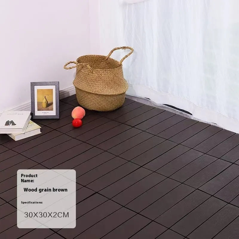 Square plastic floor tile with wood grain texture in a dark grey colour, shown on a light background.