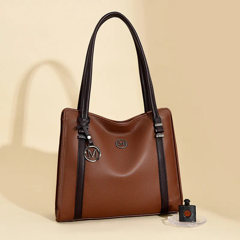 Woman holding a large soft black PU leather retro crossbody bag with double shoulder straps.