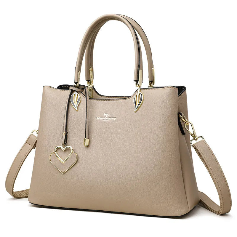 Women's black PU messenger bag with multi-layer design and visible sewing thread detail.