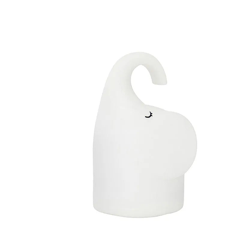 DOMI Elephant style LED night light with warm white glow on a bedside table.