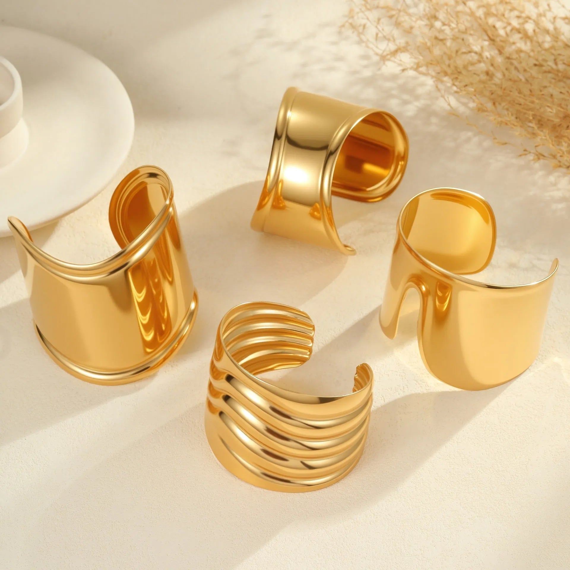 Women's gold plated stainless steel bracelet with exaggerated wide geometric wave design and niche opening