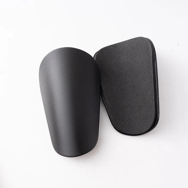 PU mini shin guards for football and sports protection in black, white, red, and blue colours.