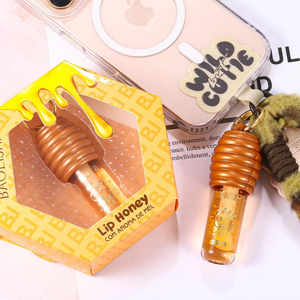 Honey lip gloss in portable keychain pannier bag packaging for on-the-go moisturising
